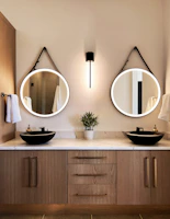 Stylish bathroom vanity with porcelain finishes and custom mirrors.