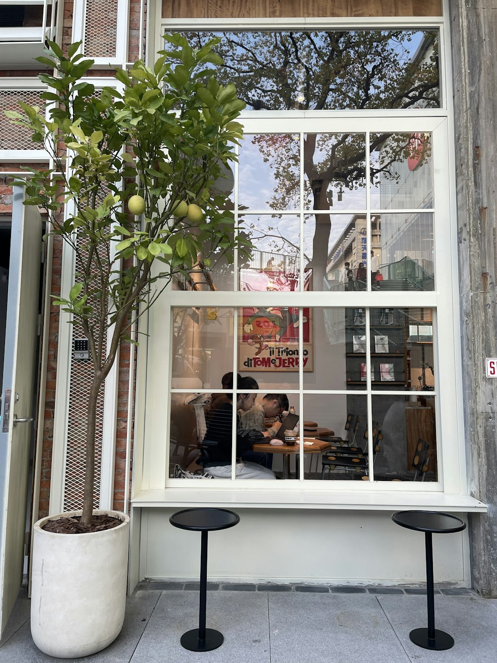 a couple of people sitting at a table in a window