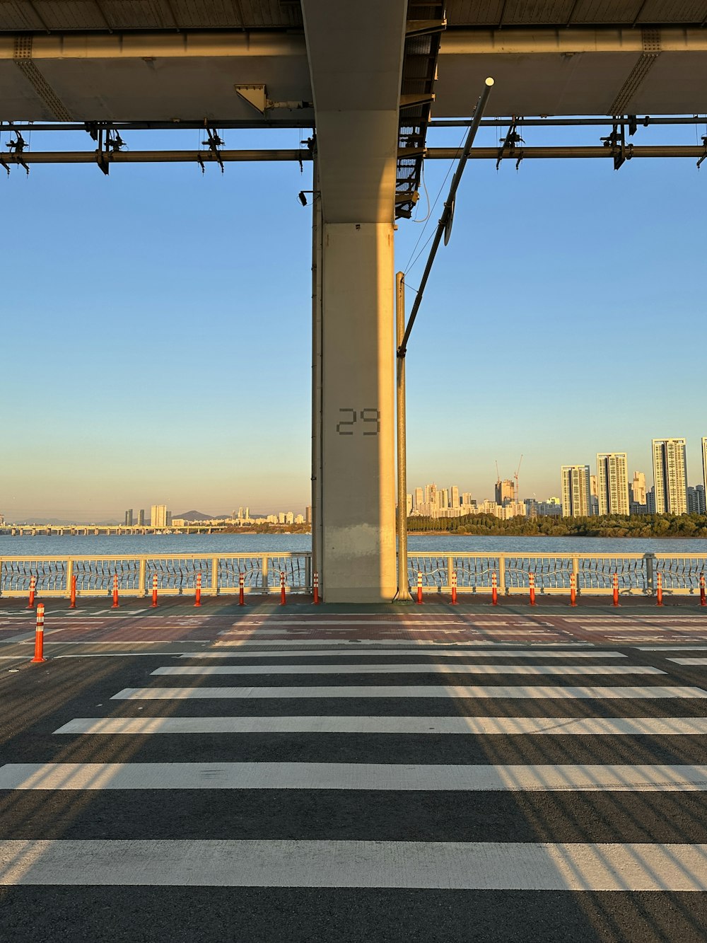 a large concrete structure with a body of water in the background