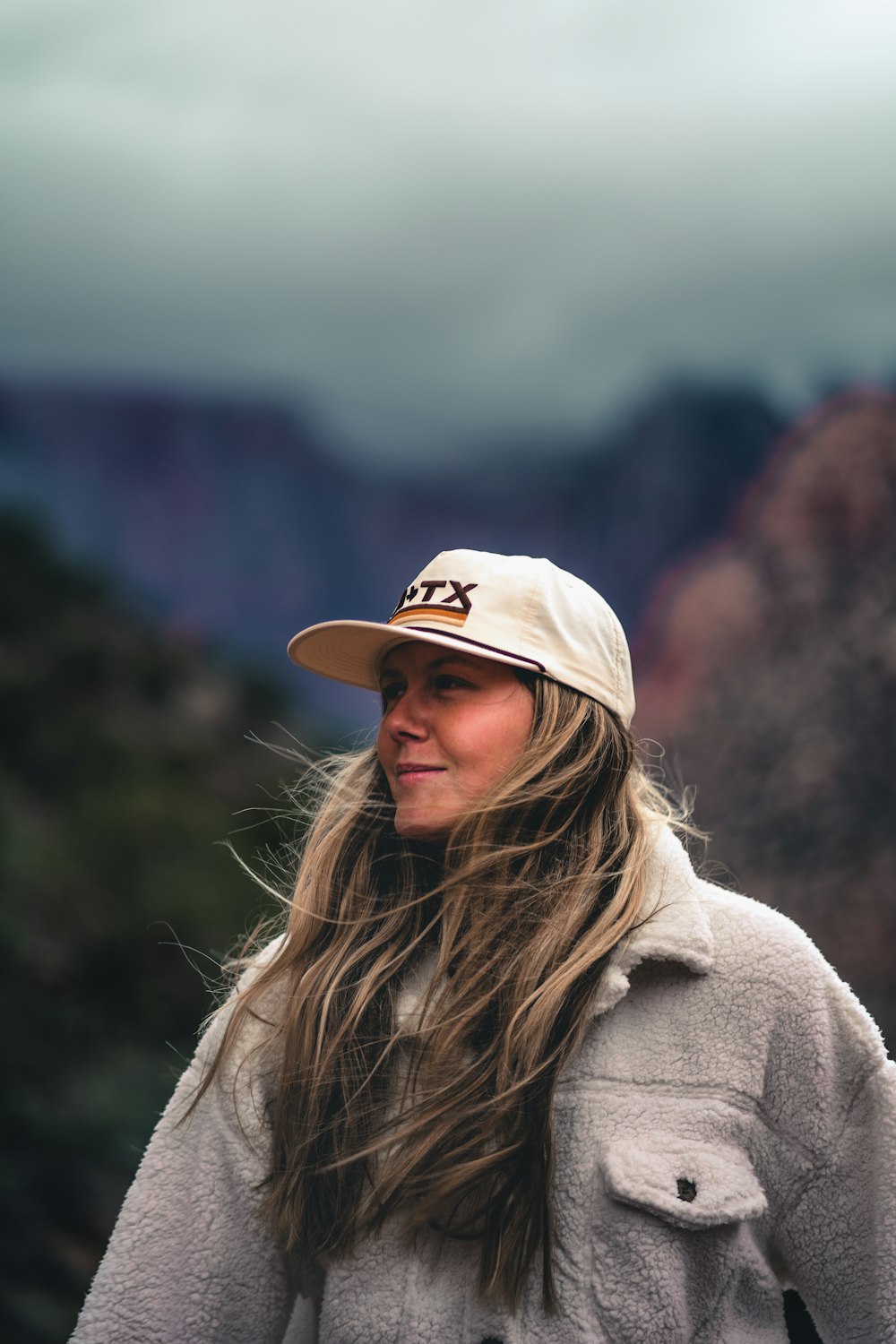 a person with long hair wearing a hat