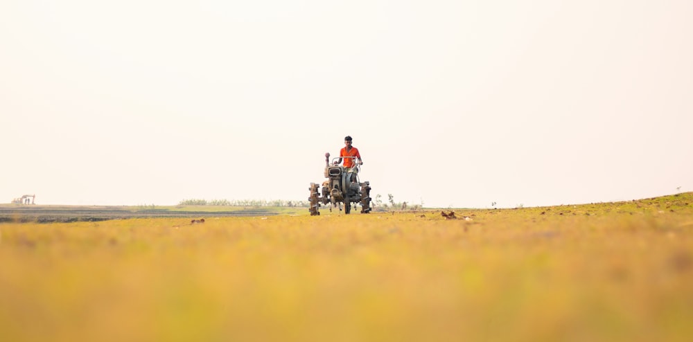 a person riding a tractor in a field