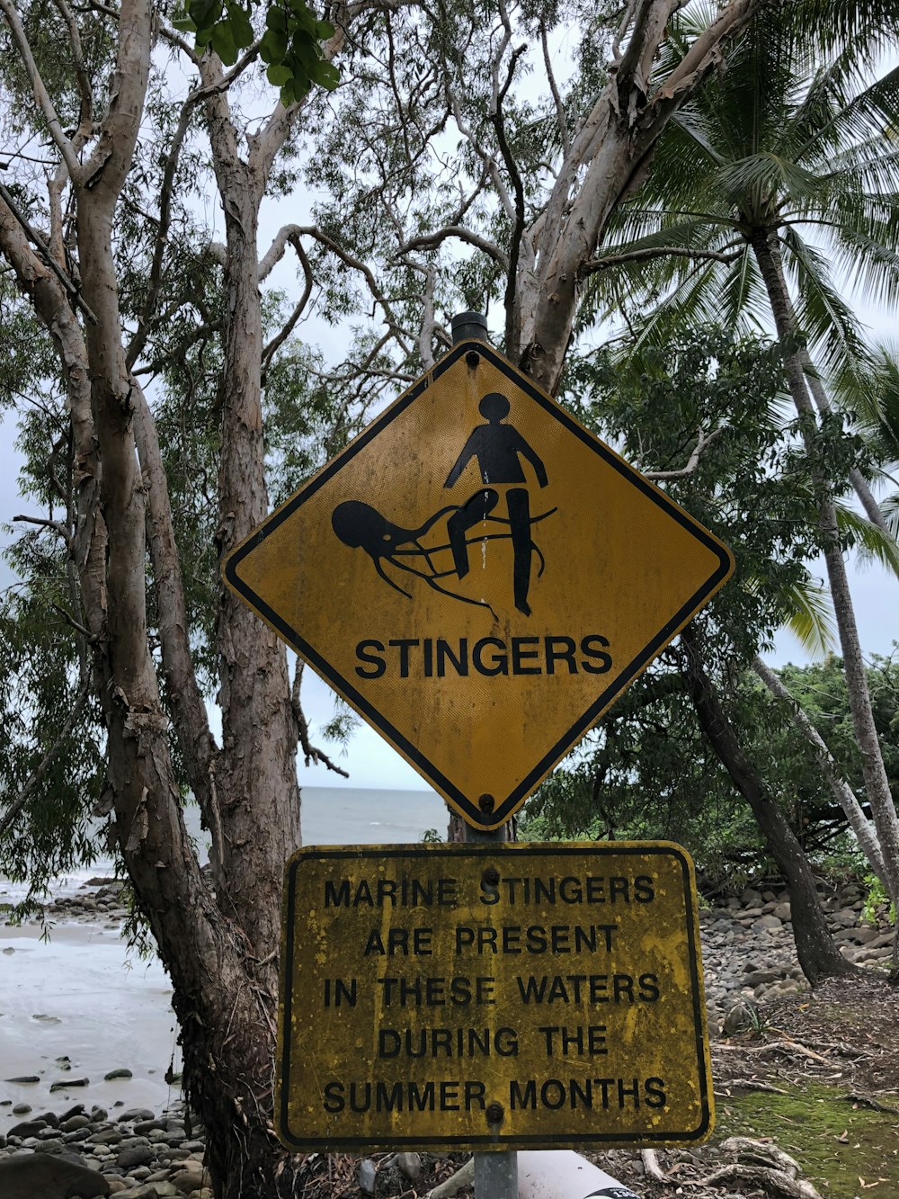 a yellow sign with a black figure on it