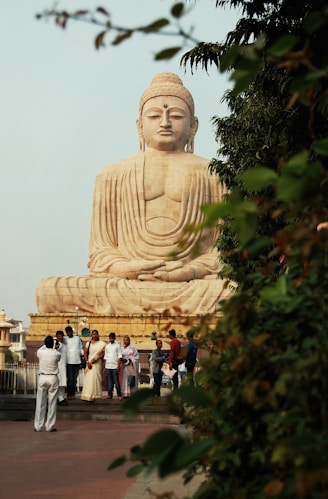 a group of people standing next to a large statue