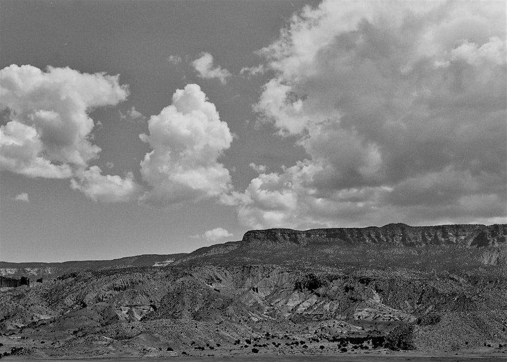 a landscape with hills and clouds