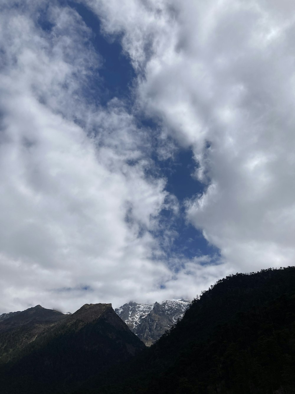 a mountain range with clouds