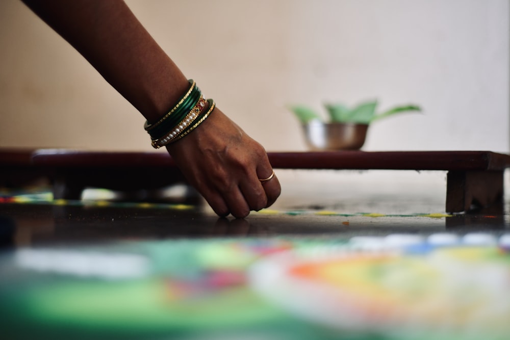 a person's hand on a pool table