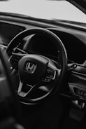 Close-up of a 2019 Honda's sleek dashboard and steering wheel.