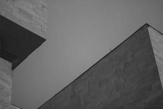 a grey building with a black roof