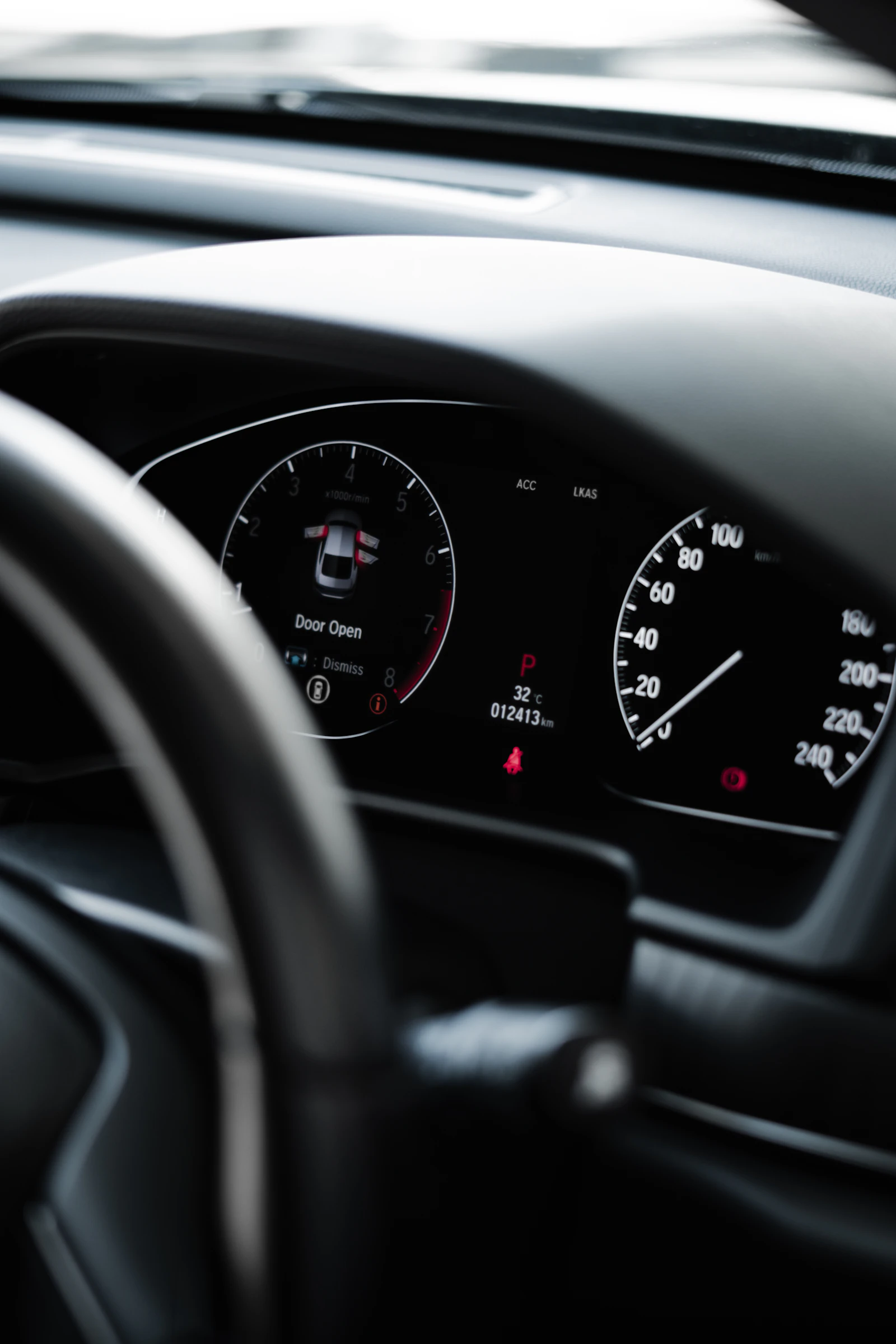 Car dashboard with a black steering wheel