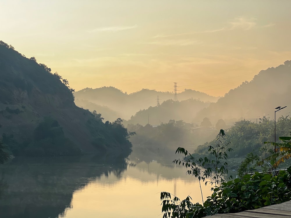 a body of water with trees and hills around it