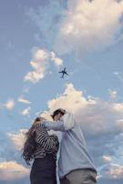 An emotional moment of a couple sharing a quiet smile during their romantic proposal flight.