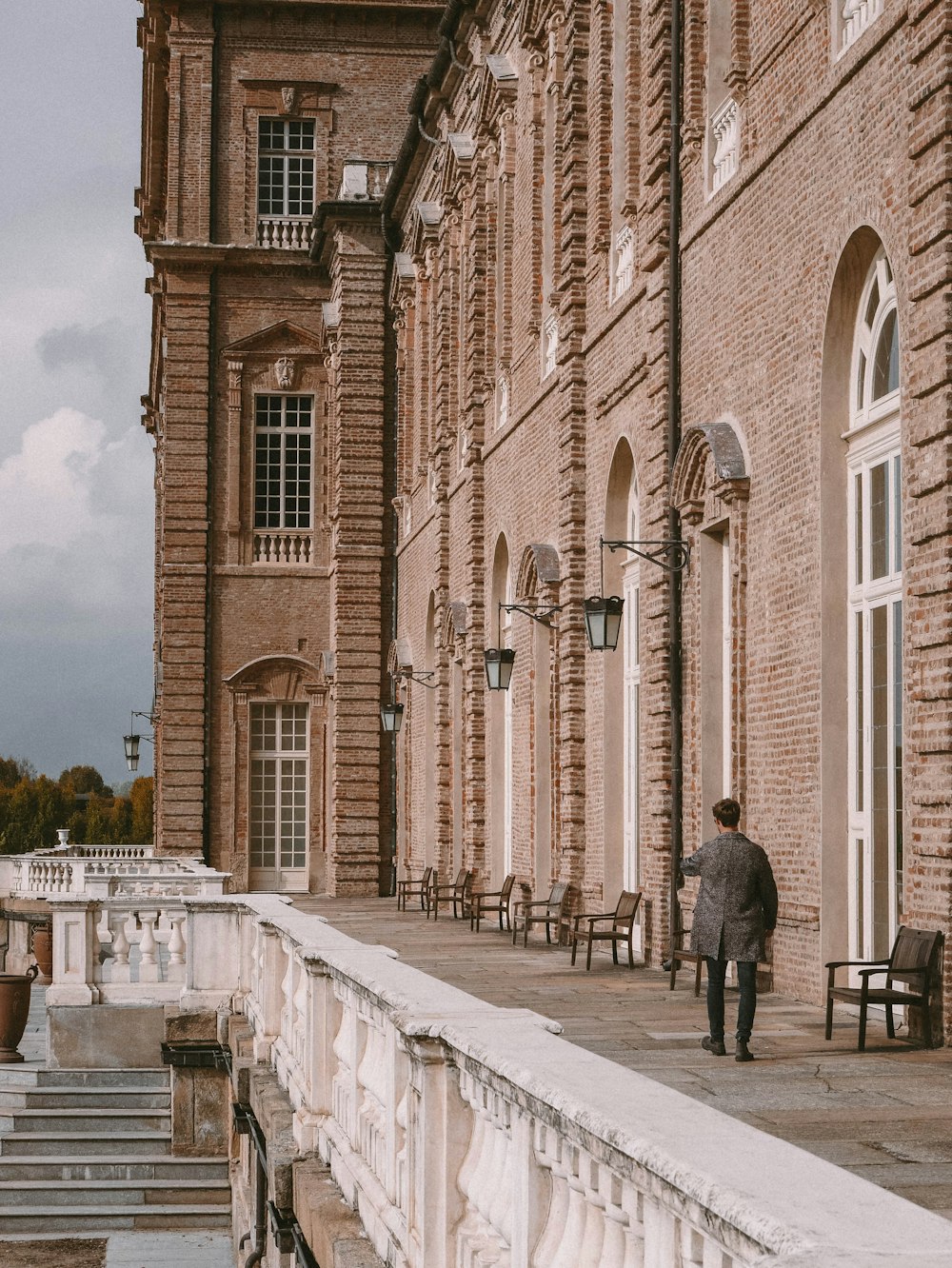 a person walking on a path between two brick buildings