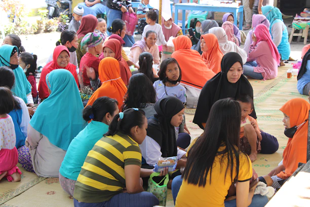A diverse group of people engaged in community activities, embodying Islamic values.