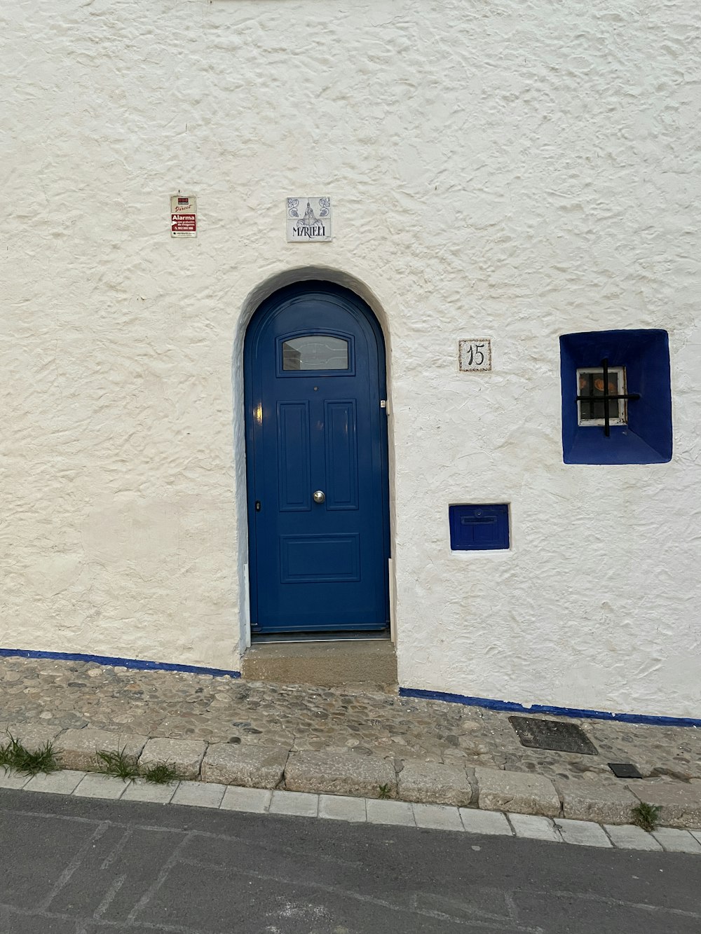 a white building with blue doors