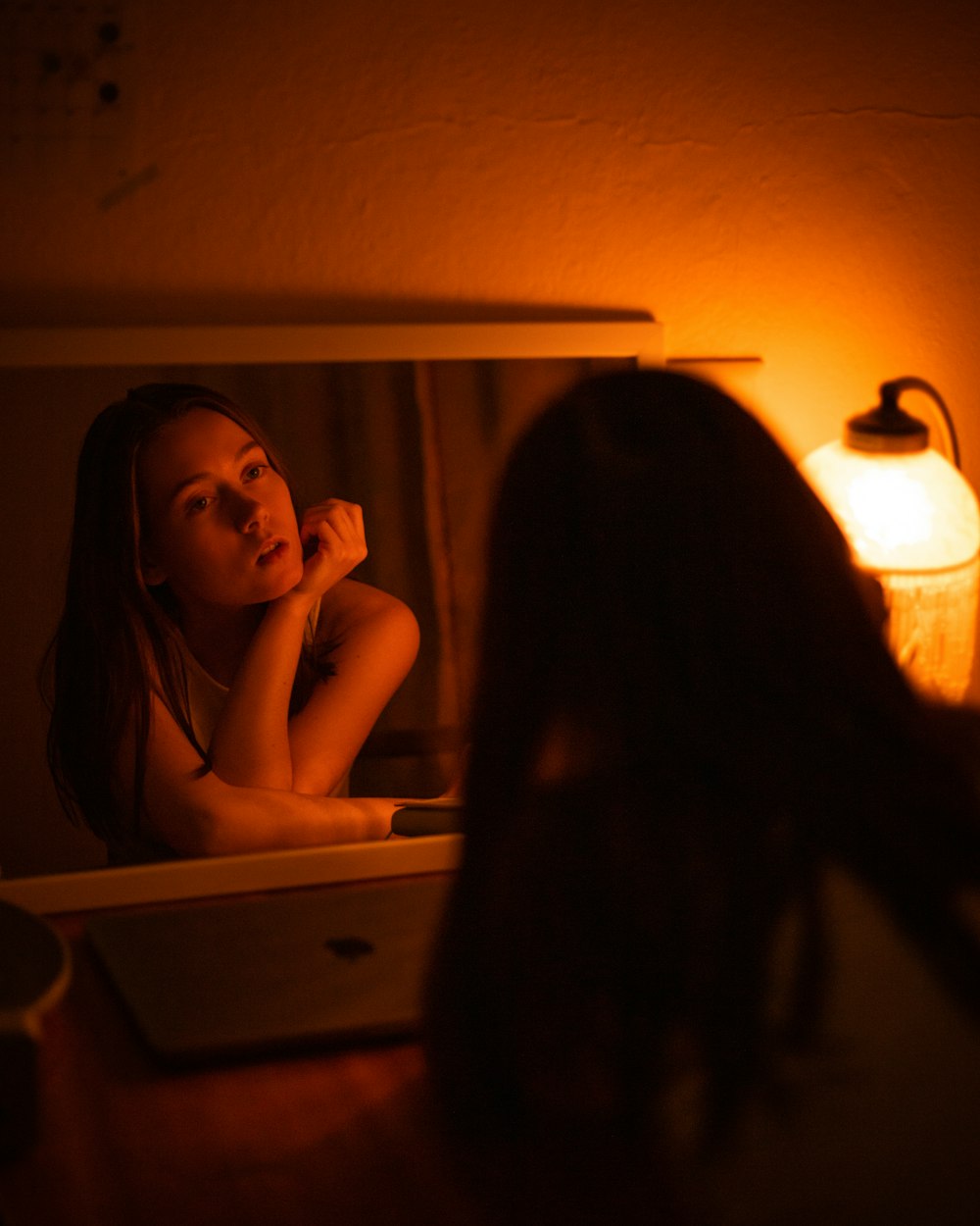 a person sitting in front of a mirror