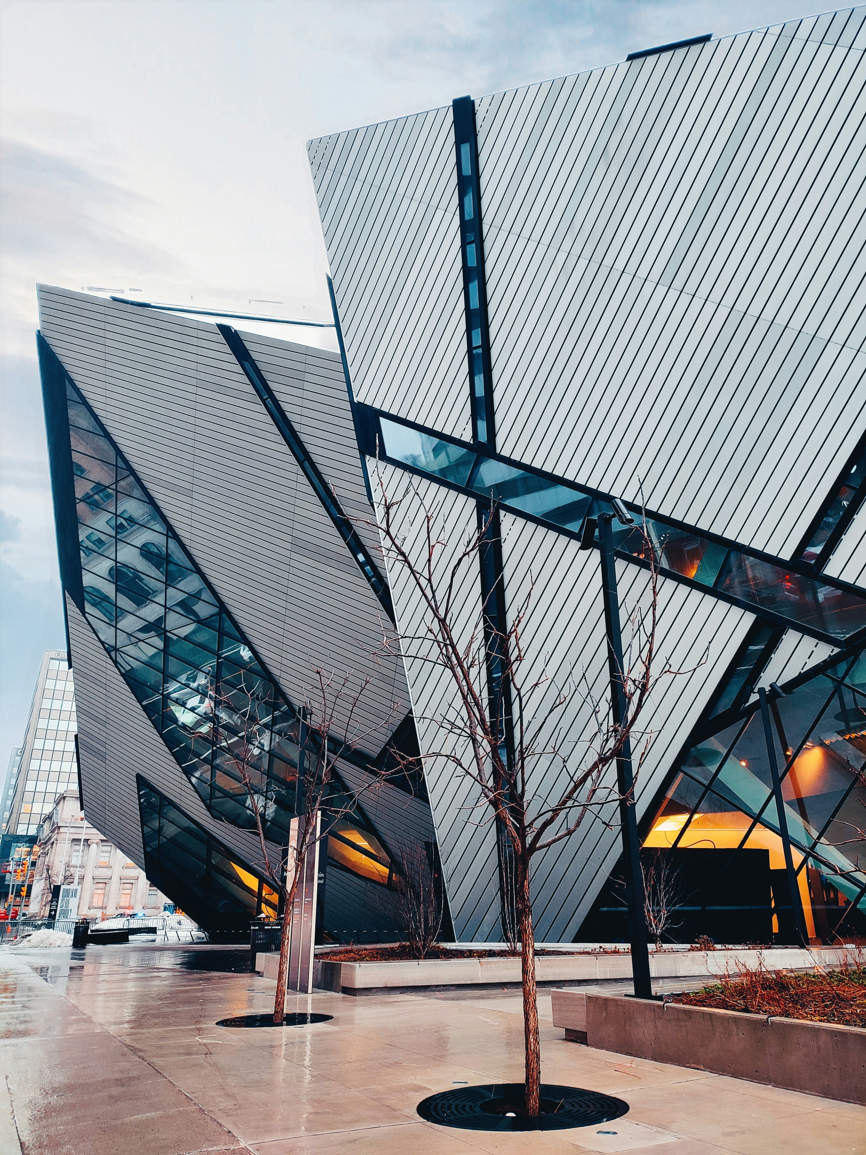 a large glass building with Royal Ontario Museum in the background