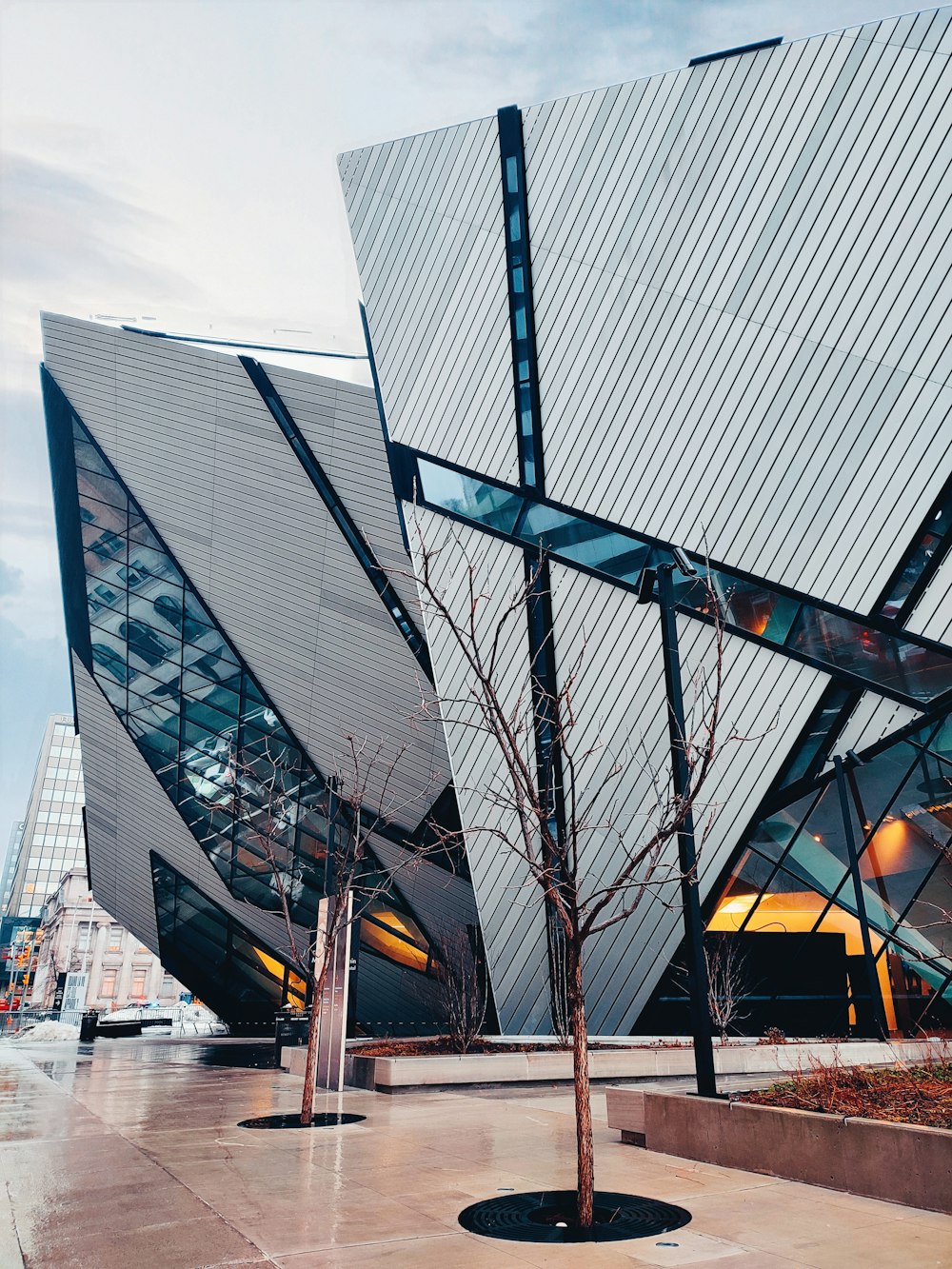 a large glass building with Royal Ontario Museum in the background