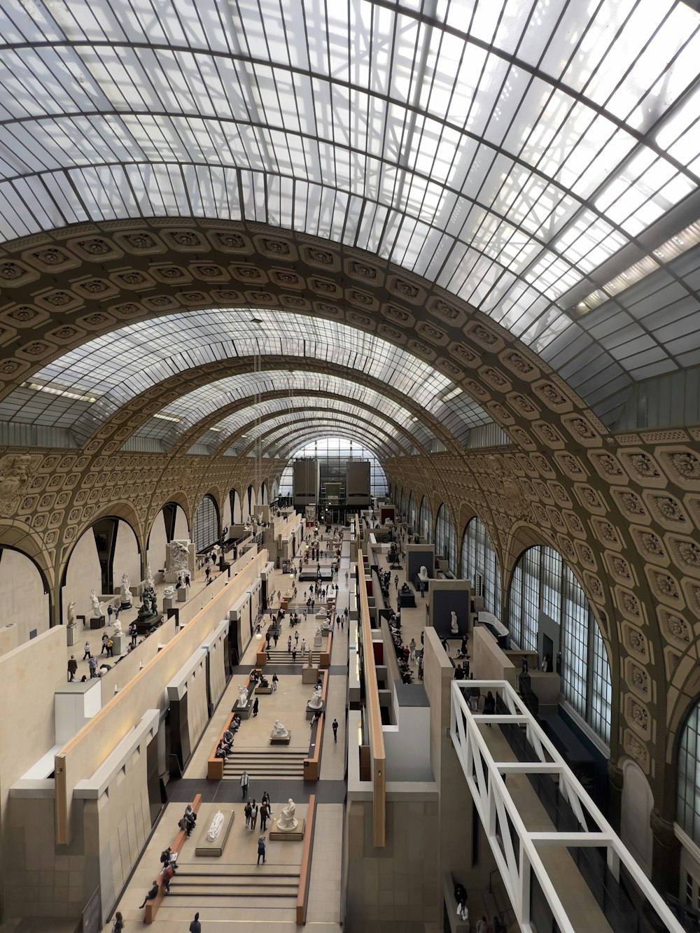 a large building with many people walking around with Musée d'Orsay in the background