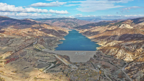 A panoramic view of a large porosity reservoir nestled in a natural landscape.