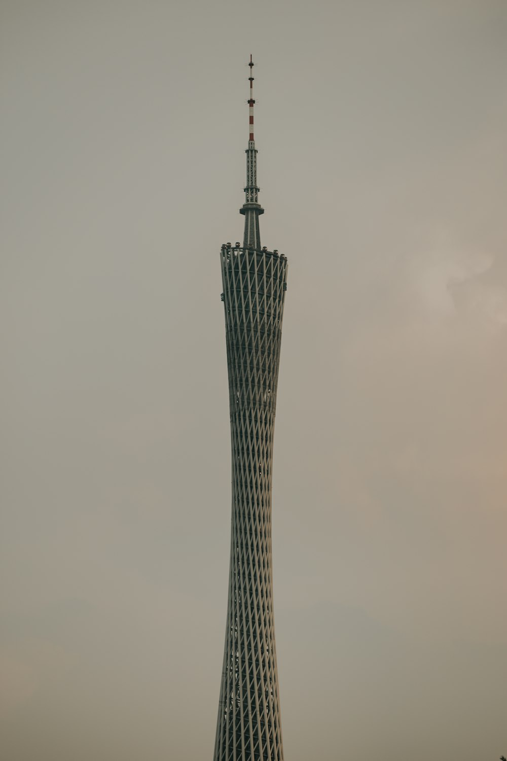 a tall building with a pointy top with Tokyo Skytree in the background