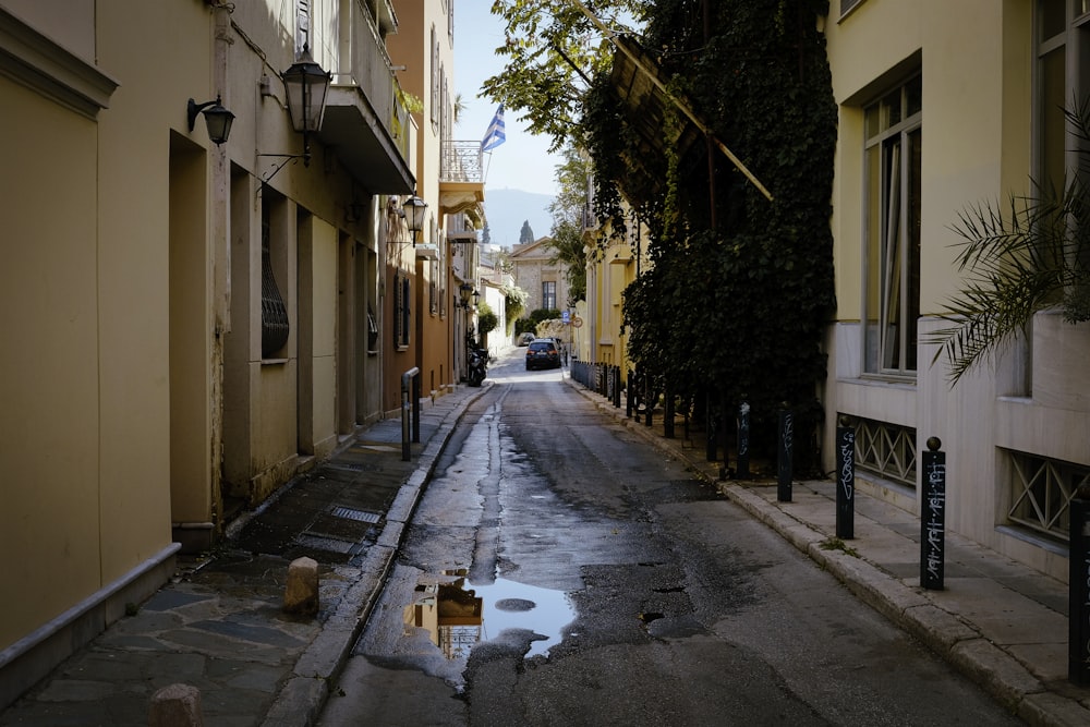 a wet street between buildings