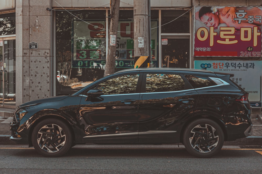 a black car parked on the side of a street