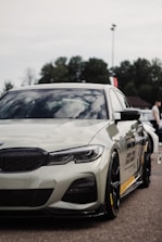 A sleek customized car with unique decals and modifications parked outdoors.