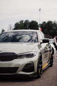 A sleek customized car with unique decals and modifications parked outdoors.