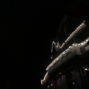 Commercial building adorned with elegant, custom-designed holiday lights glowing against the night sky.