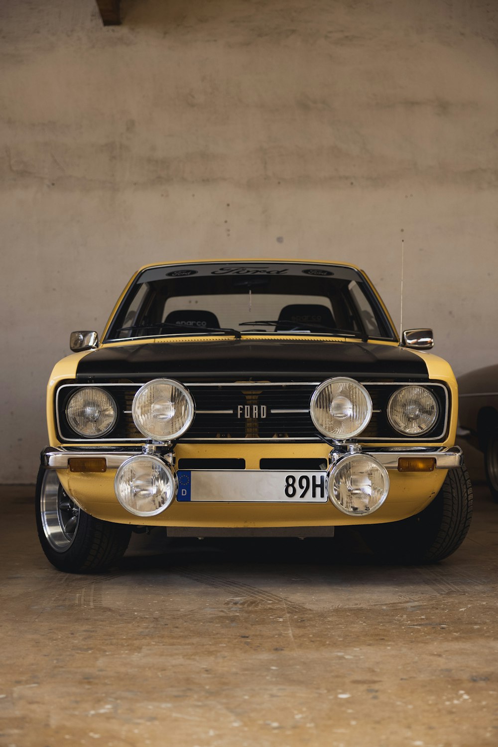 a yellow car parked in a garage