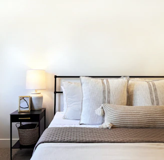 a bed with a basket and pillows