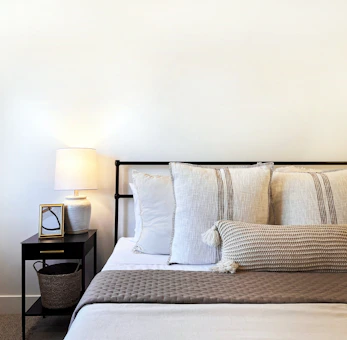 a bed with a basket and pillows