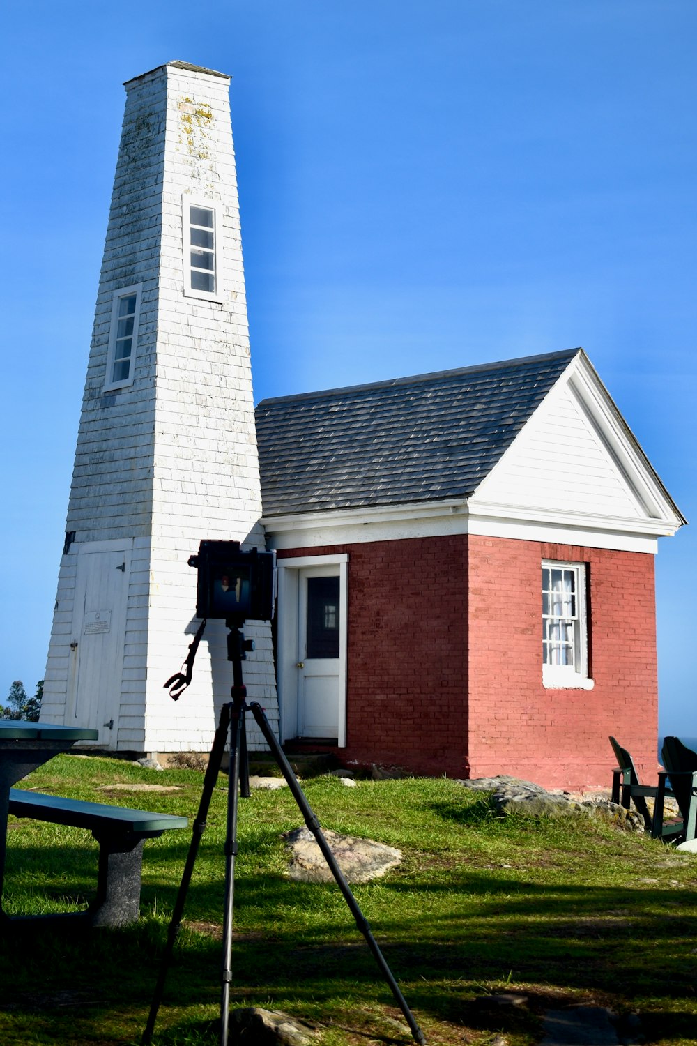 a camera on a tripod in front of a brick building