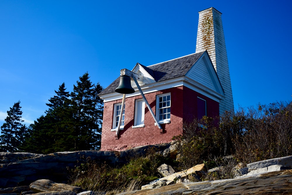 a red house with a bell on top