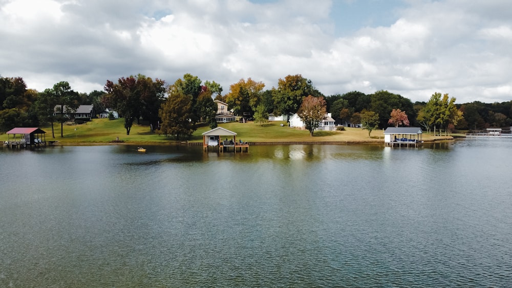 a body of water with houses and trees around it