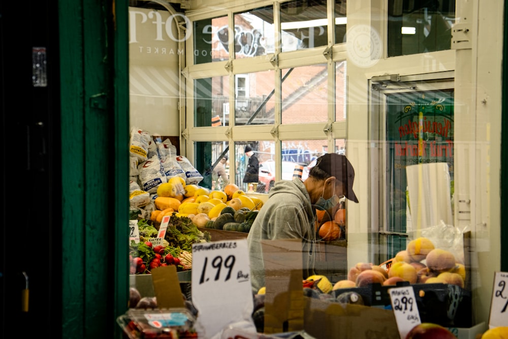 a person in a hat selling fruits