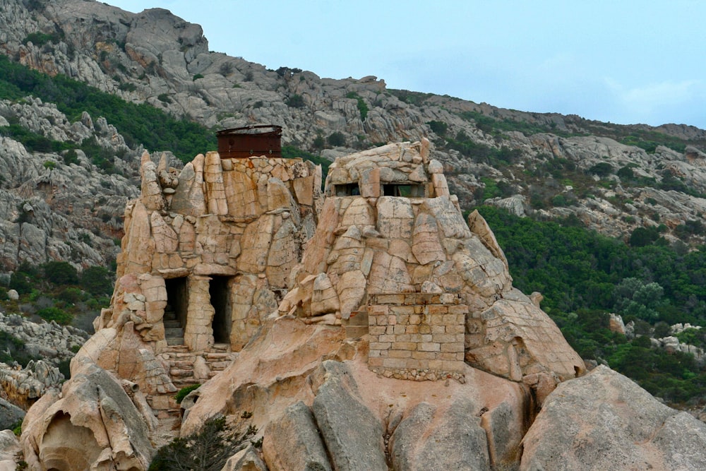 a stone structure on a rocky hill