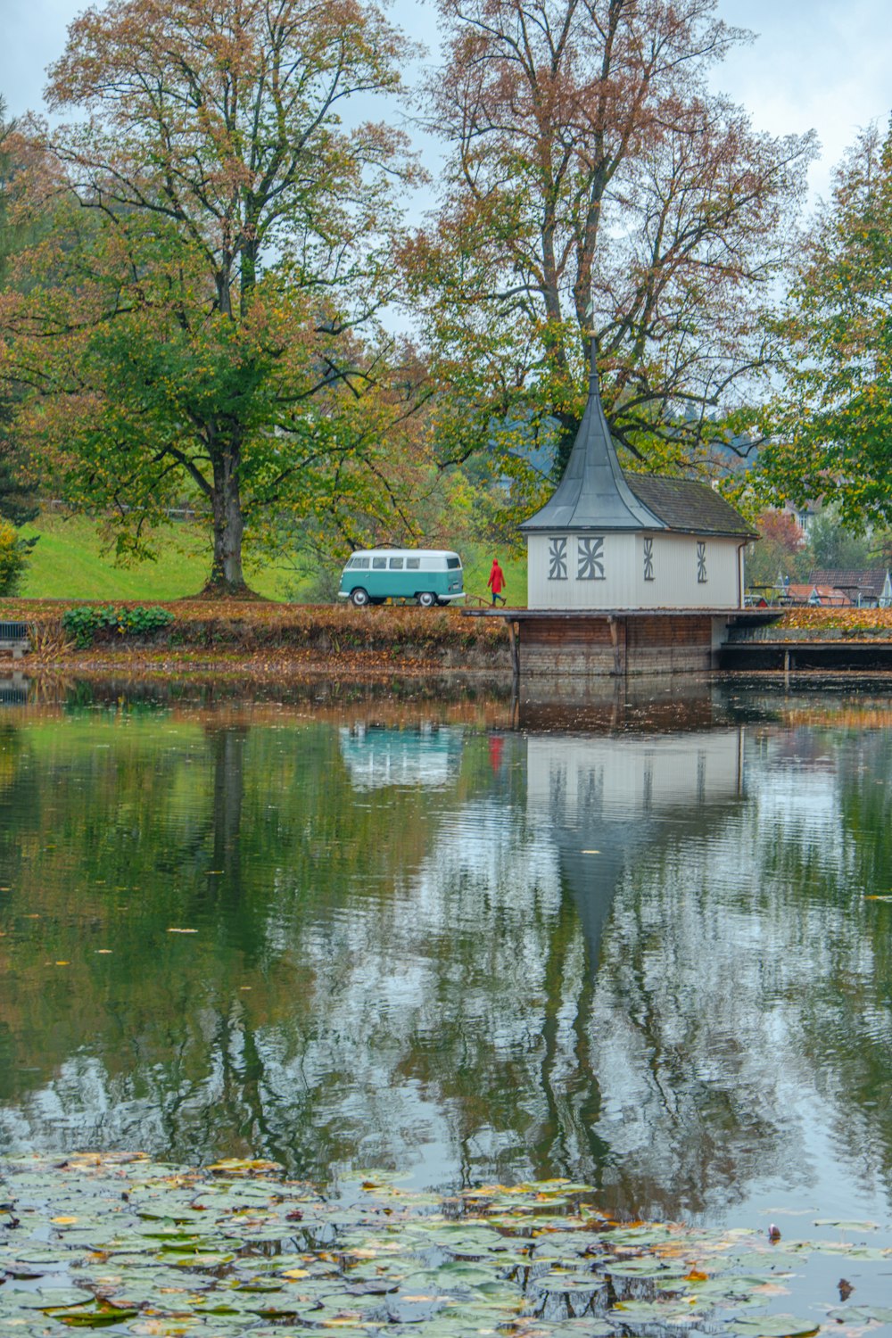 a body of water with a building and trees around it