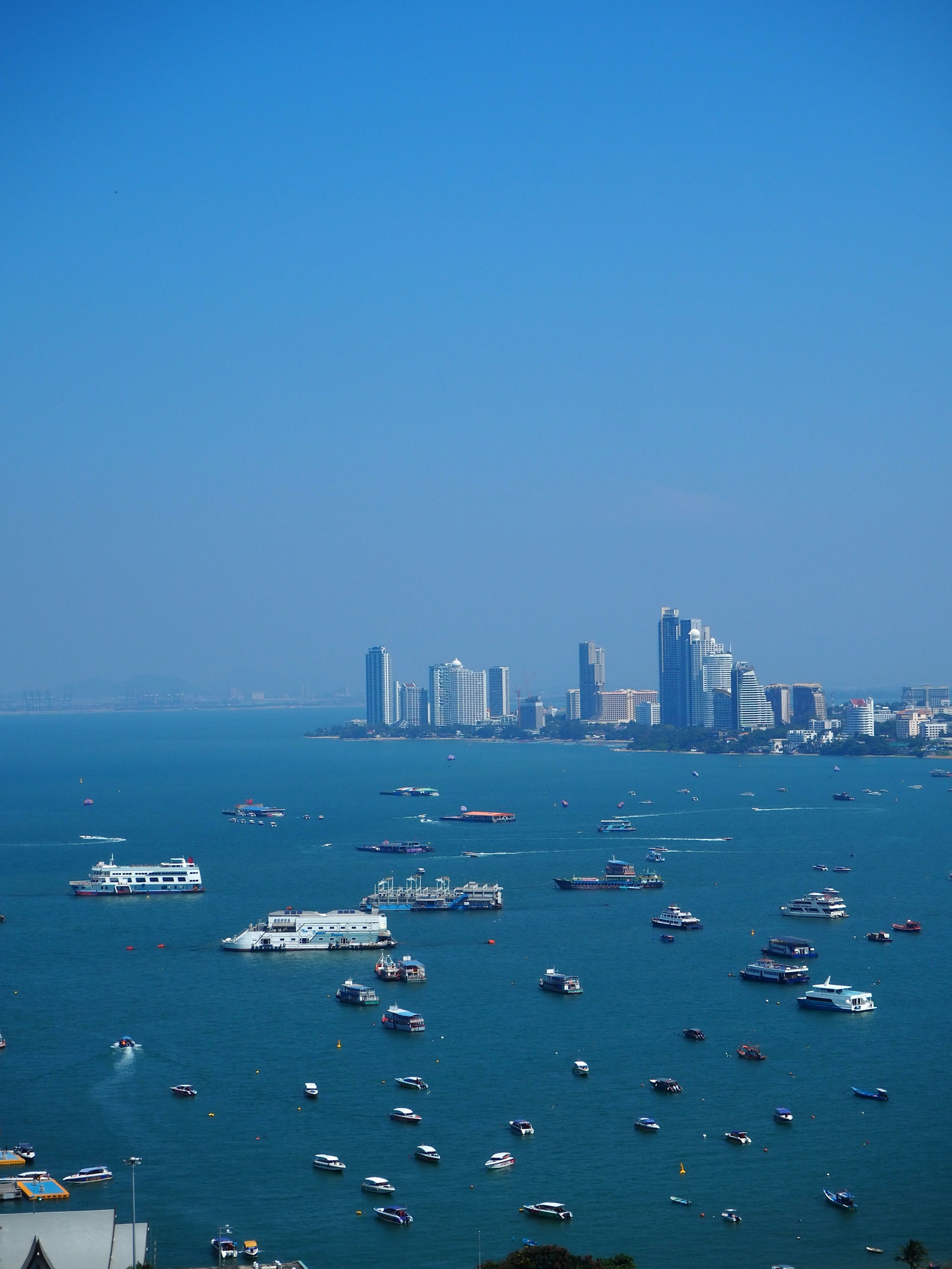 a body of water with boats in it and a city in the background