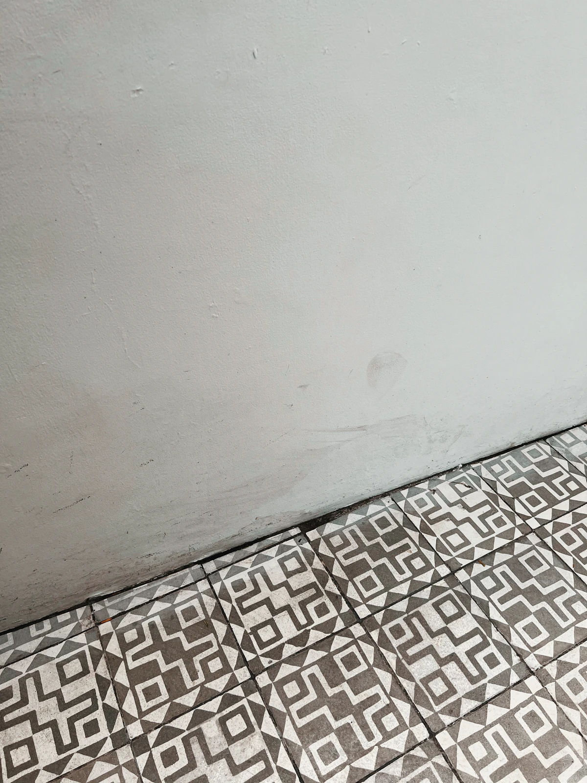 Professional tile installation with precise layout and even grout lines on a bathroom floor