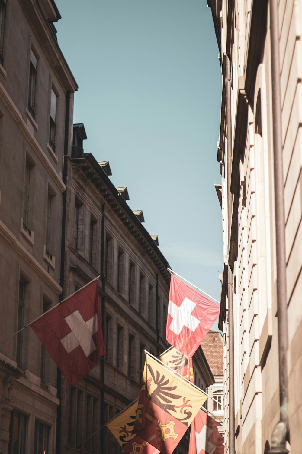 a row of buildings with flags