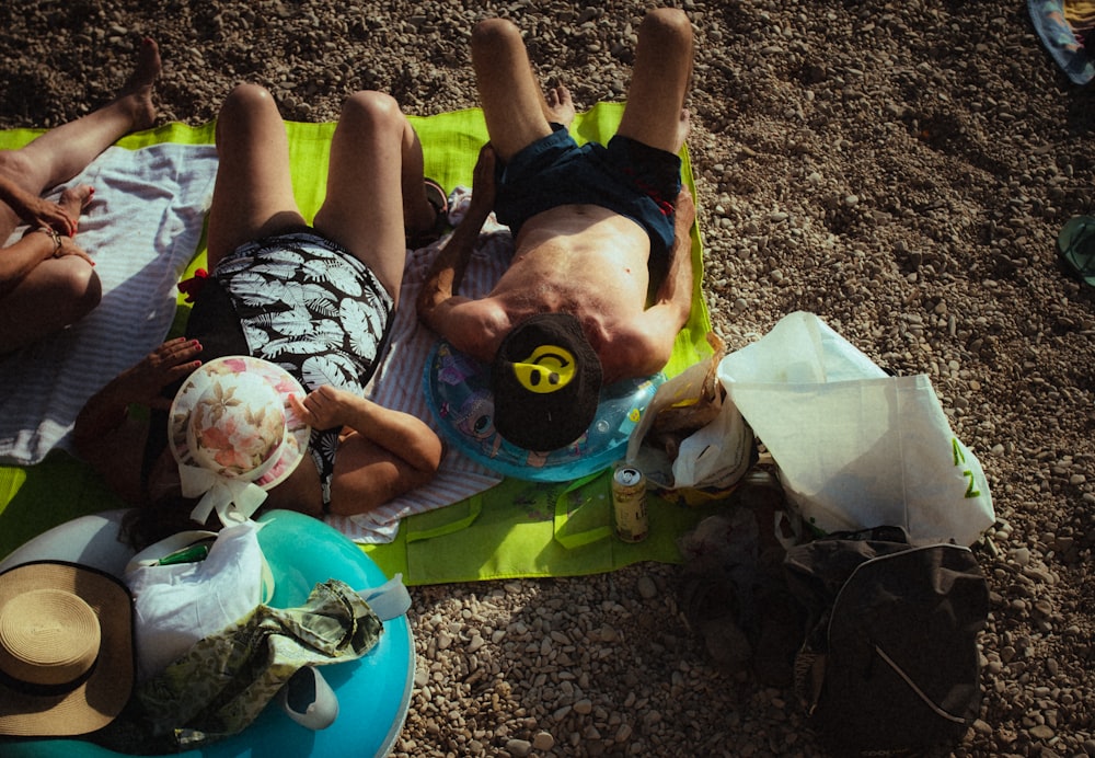 a person lying on the ground with a baby in the lap