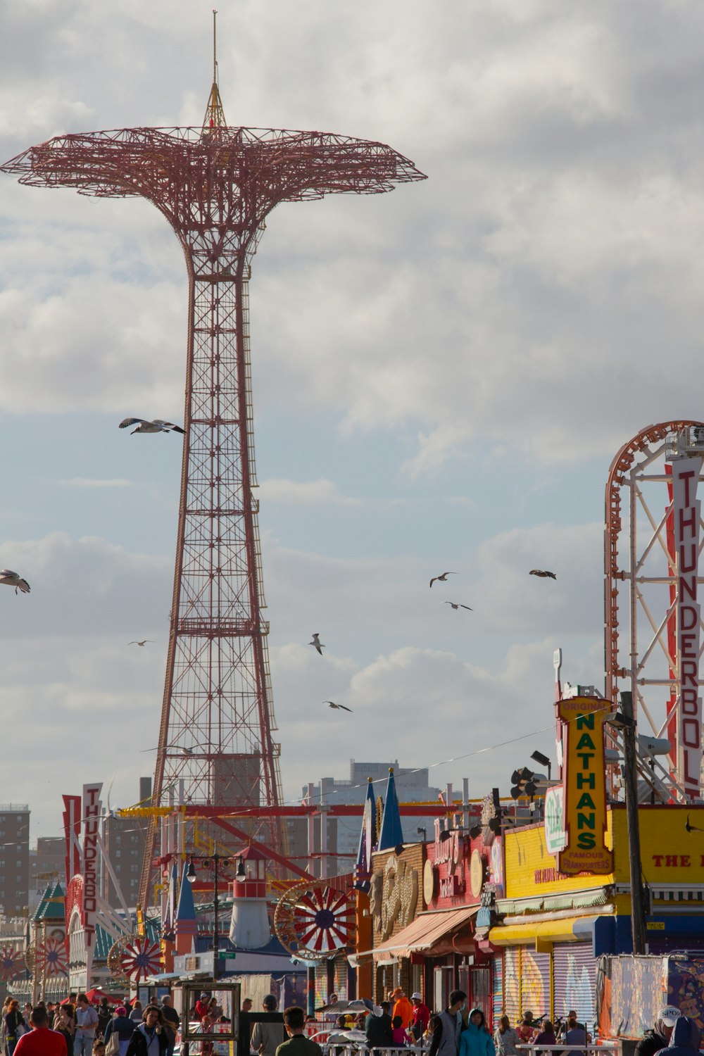 a tall tower with birds flying around