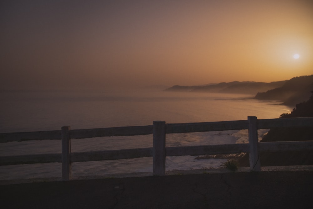 a fence in front of a body of water