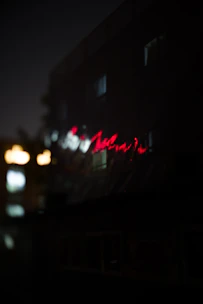 A softly glowing neon sign that reads 'nexvía' against a dark, blurred background.