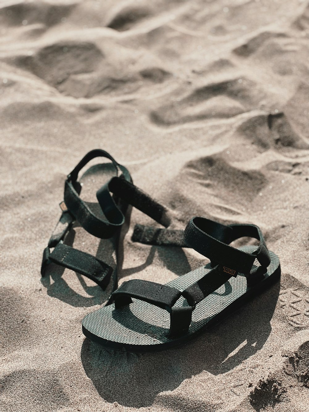 a pair of sandals on sand