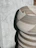 Close-up of woven wall baskets hanging on a textured wall, showcasing their natural fibers.
