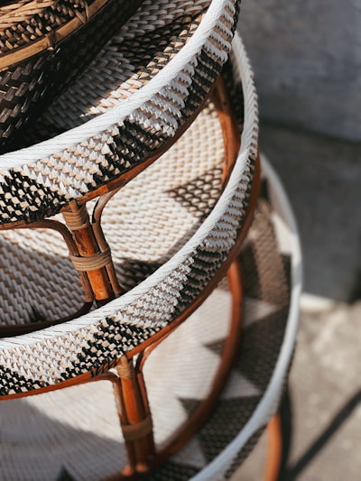 Close-up of a woven rattan ottoman showing its intricate natural texture and sturdy craftsmanship.