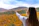 A smiling Malaysian woman enjoying a scenic autumn view in Japan.