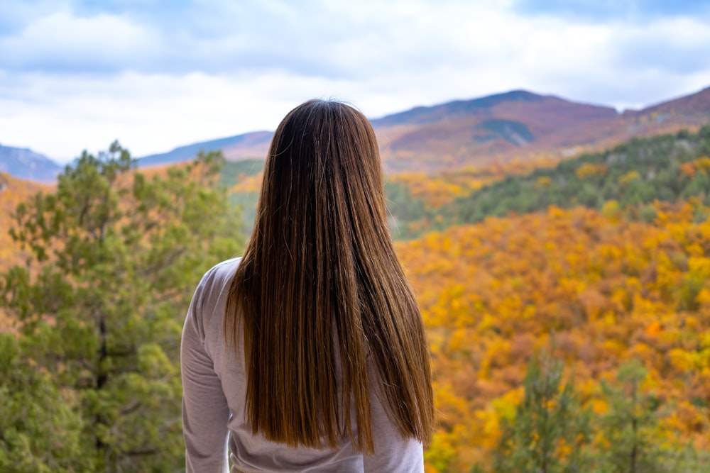 a woman looking at a forest